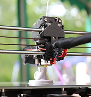 3D printer photo of a white abstract object being printed with a window of green leaves and natural light blurry in the background