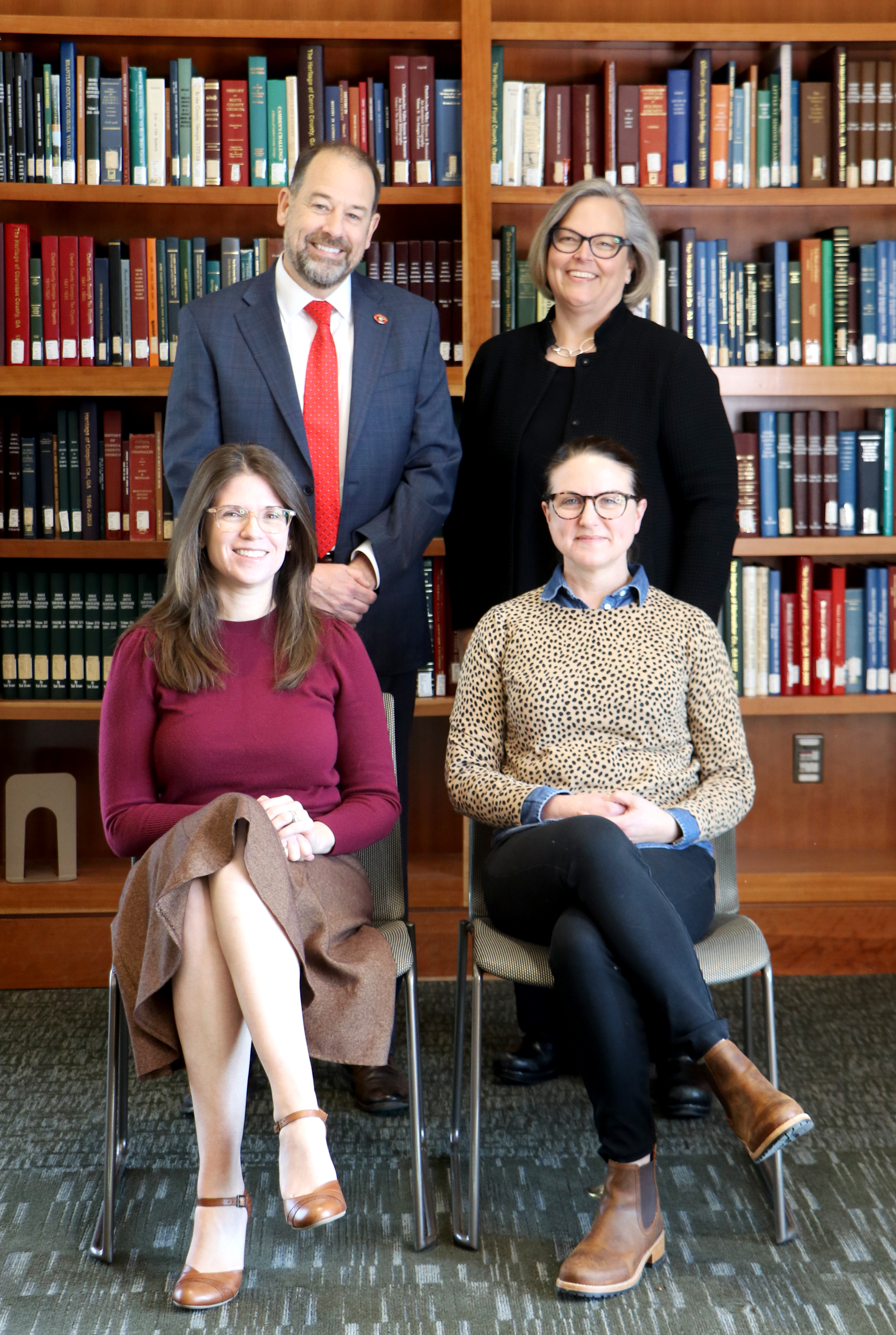 Pictured are UGA Libraries' administrative leadership team in front of a book case.Top row: Toby Graham, Emily Gore. Bottom row: Kat Stein, Sara Wright.