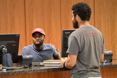Staff member helping patron at circulation desk