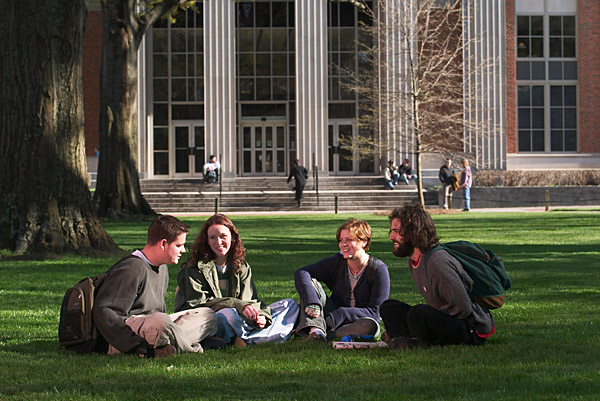 undergraduate students sitting on the lawn outside Main Library