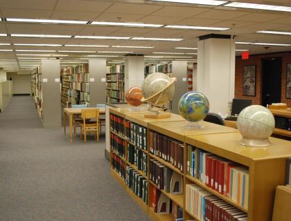 Interior of Map and Government Information Library, showing globes and shelves of books
