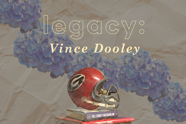 Image of a UGA football helmet atop a small pile of books about Dooley
