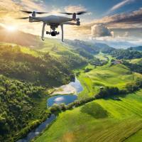 drone flying and collecting environmental data over a green lush landscape